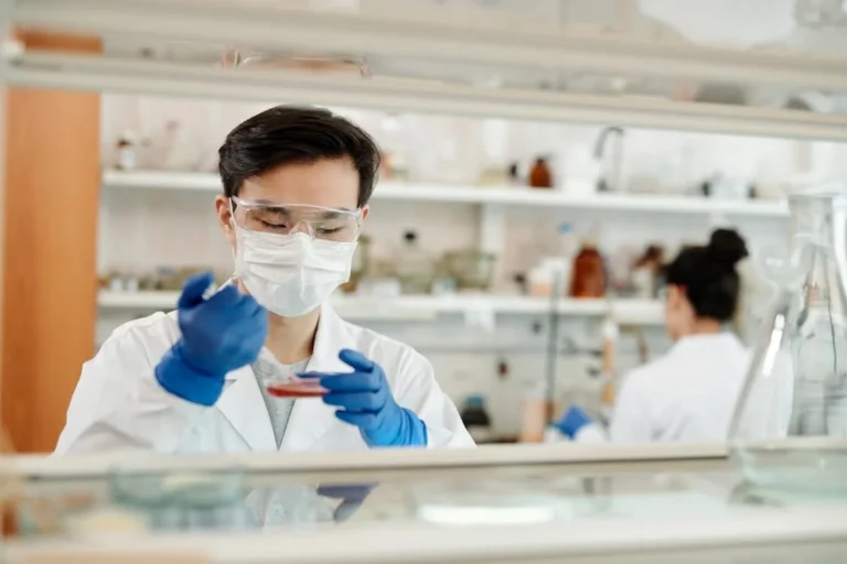 A scientist wearing protective gear working in a laboratory, conducting research to advance healthcare and medical solutions.