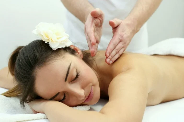 Woman receiving a relaxing massage therapy session, promoting muscle relaxation and stress relief.