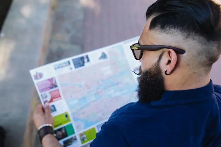 A man analyzing a map, symbolizing geotargeting and geofencing strategies for location-based digital marketing campaigns.