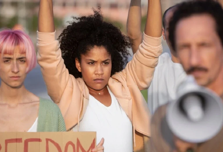 Protesters holding signs during ethan clieon blm riots, illustrating the power of social media in spreading information and misinformation.