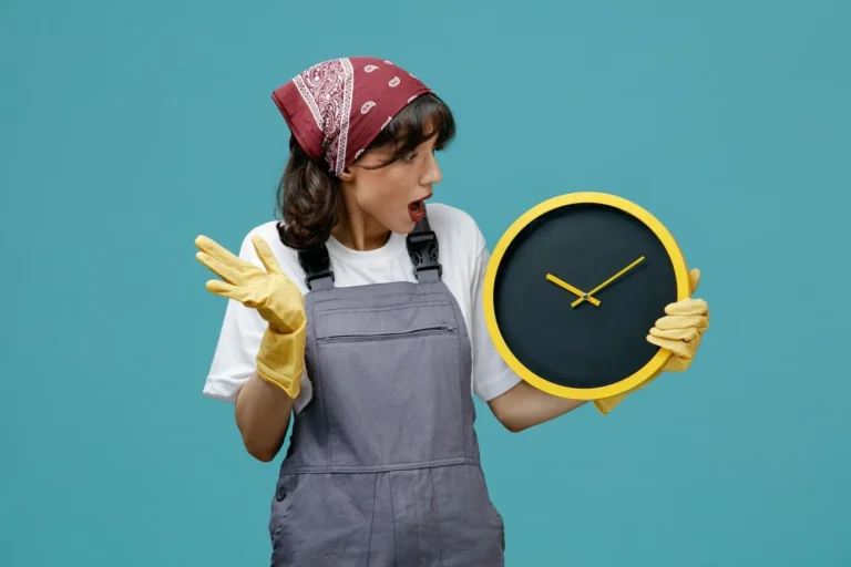 A professional cleaner wearing gloves and holding a yellow clock, emphasizing the time required for end-of-lease cleaning.