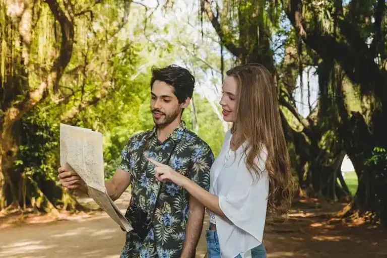 Tourists exploring nature with a map near Bandipur, planning their stay at one of the best resorts in Bandipur.