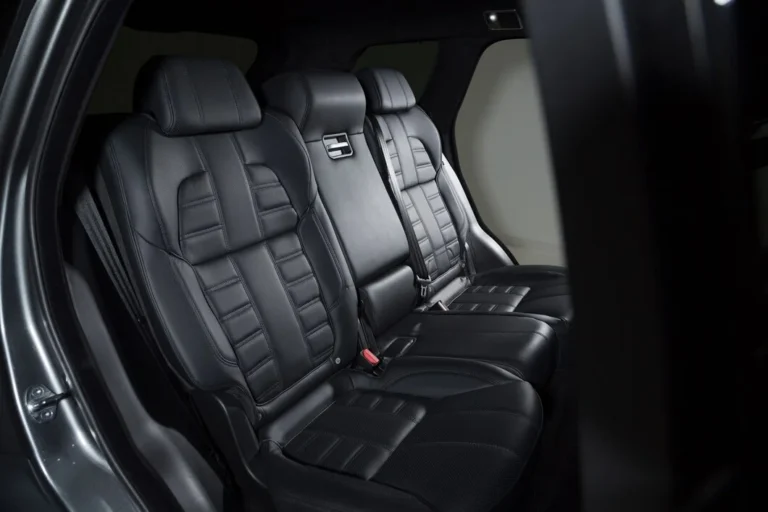 Luxury car interior with black custom floor mats providing protection and a premium aesthetic.