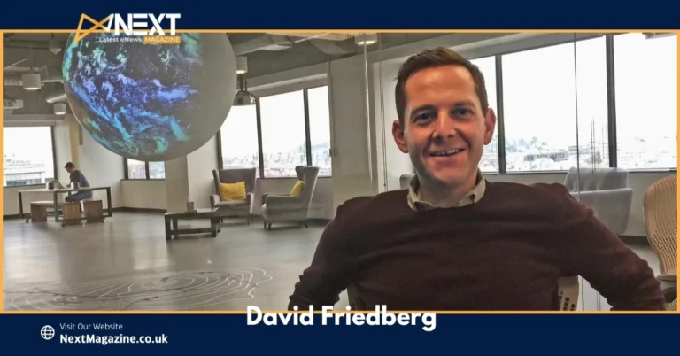 David Friedberg sitting in a modern office space with a futuristic globe display in the background.