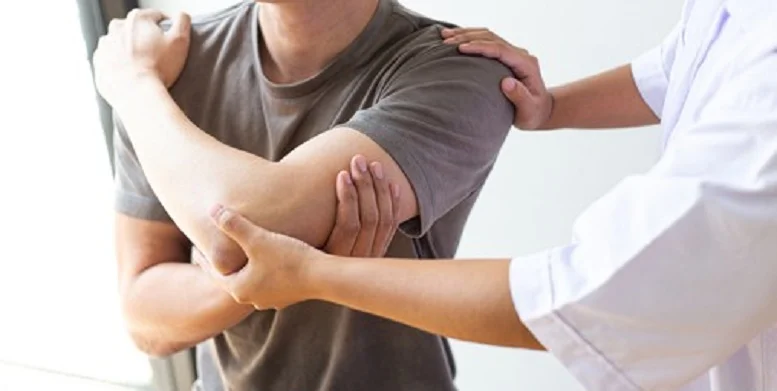 A physical therapist helping a man recover from a workout injury. Proper form and recovery are key to injury prevention in fitness.