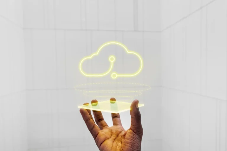 A hand holding a glowing cloud icon, symbolizing cloud collaboration tools for secure and efficient remote teamwork.