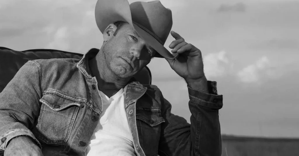 Taylor Sheridan wearing a cowboy hat and denim jacket, the successful creator behind Yellowstone whose net worth reached $70 million through his TV empire and ranch investments.RetryClaude can make mistakes. Please double-check responses.
