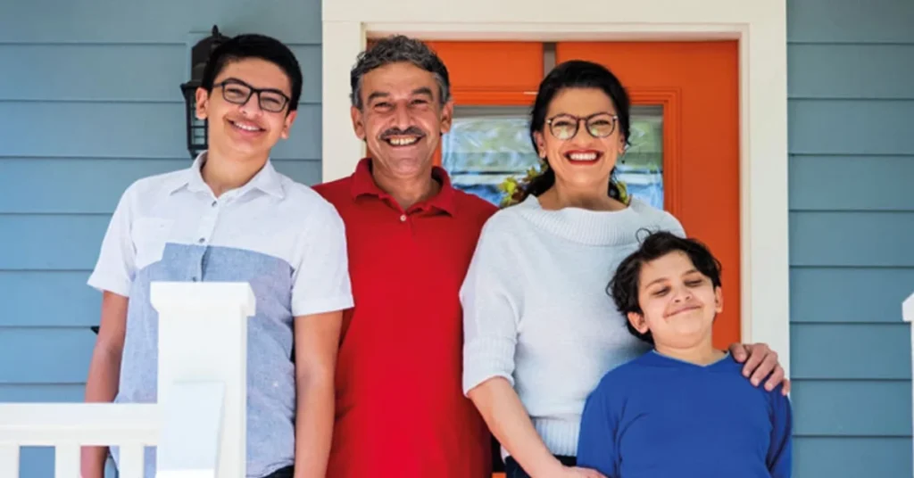 Fayez Tlaib smiling with family on porch, capturing a warm family moment for an article about Fayez Tlaib