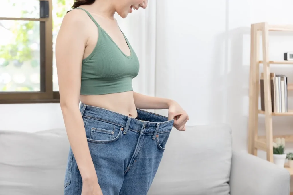 Woman showing loose skin after weight loss with tips for tightening naturally and with treatments