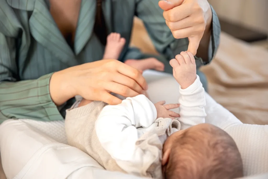 Night nurse caring for a newborn while parents rest at night