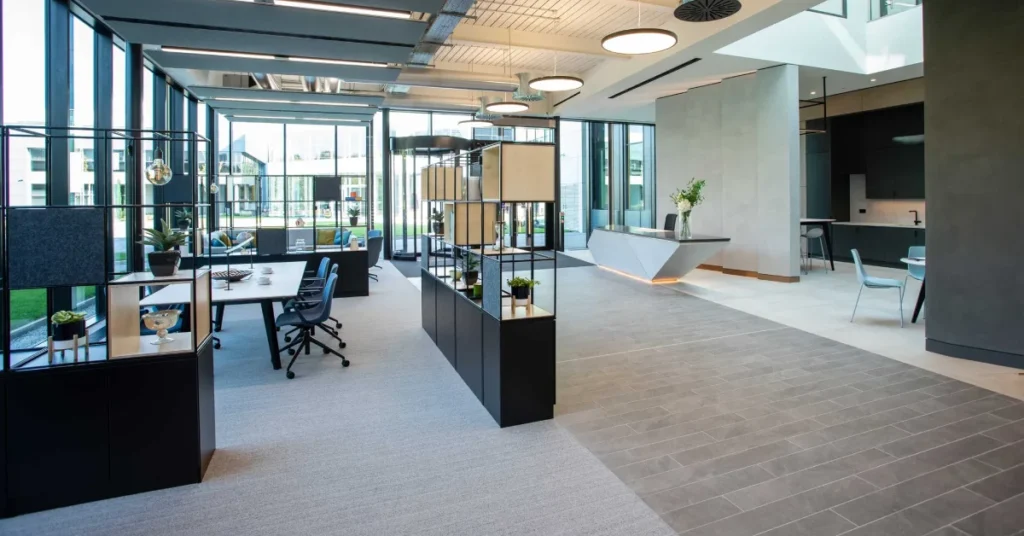 Modern office interior with cybersecurity icons and digital protection elements overlaid, representing the fusion of physical workspace design and digital security