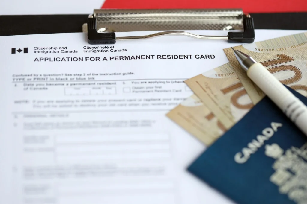 Person reviewing Permanent Resident Card renewal forms in Canada